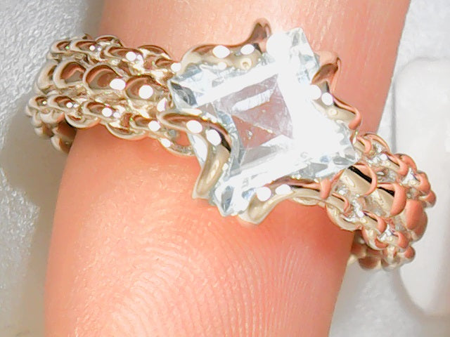 Blue topaz ring with raided sh